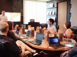 man standing in front of people sitting beside table with laptop computers {{brizy_dc_image_alt entityId=